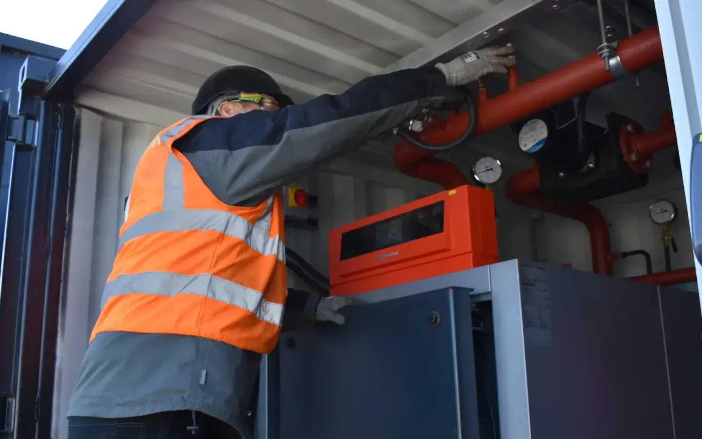 Mechanical technician servicing HVAC piping and equipment