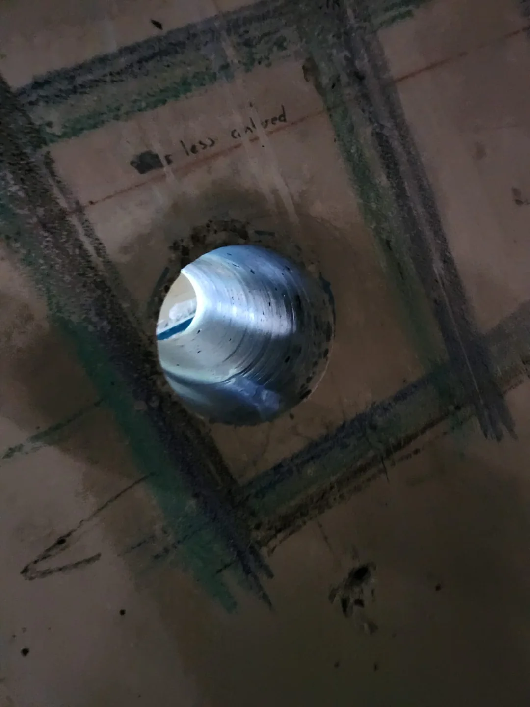 Completed round opening through concrete within a marked grid