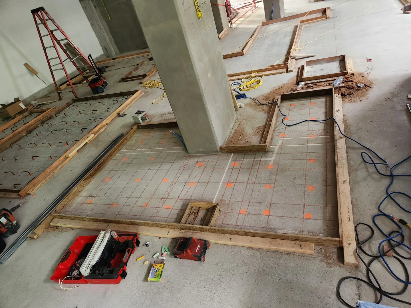 Concrete floor with a marked grid and highlighted locations around a column