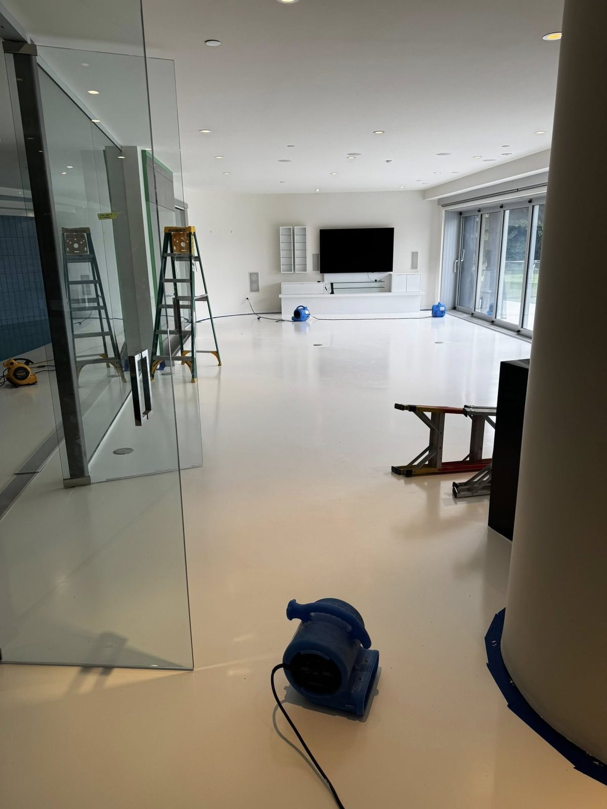 Large living and pool room with masked column during interior painting in Jericho Beach