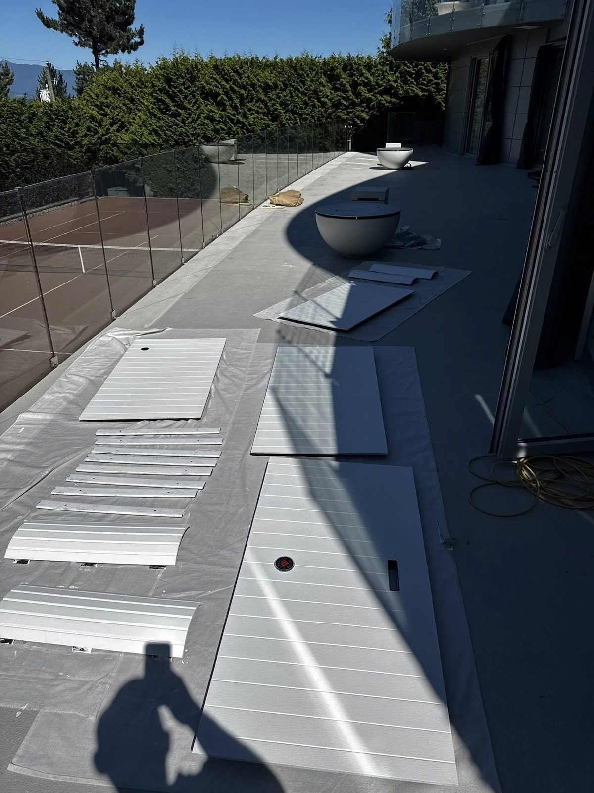 Outdoor panels refinished on the terrace overlooking the tennis court at a Jericho Beach estate