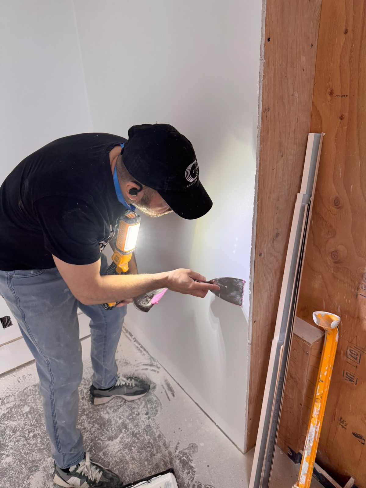 Detailed Level 5 finishing inspected under raking work light during Whistler chalet renovation