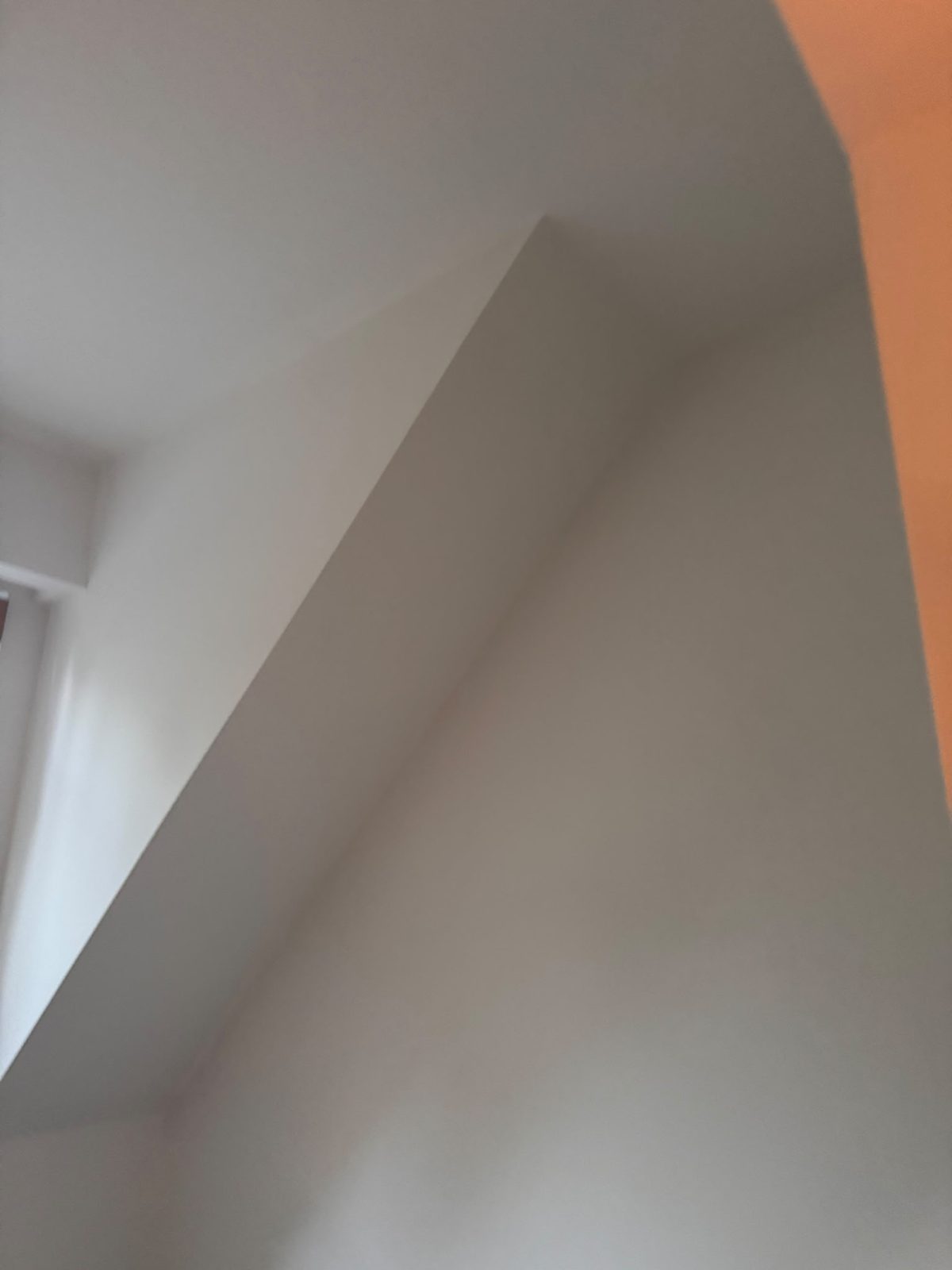 Smooth Level 5 finished angled walls meeting cleanly at a sharp corner in the Whistler chalet