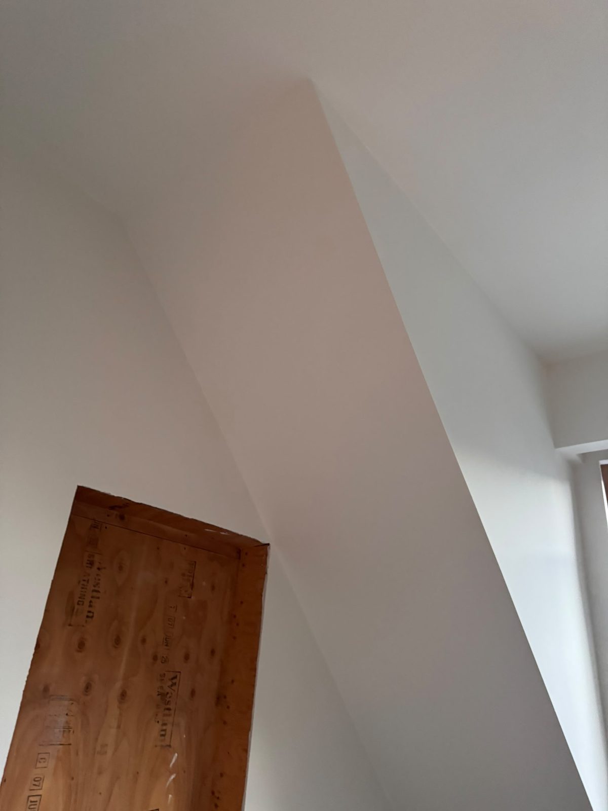Finished sloped ceiling with a clean valley intersection after Level 5 drywall finishing in Whistler