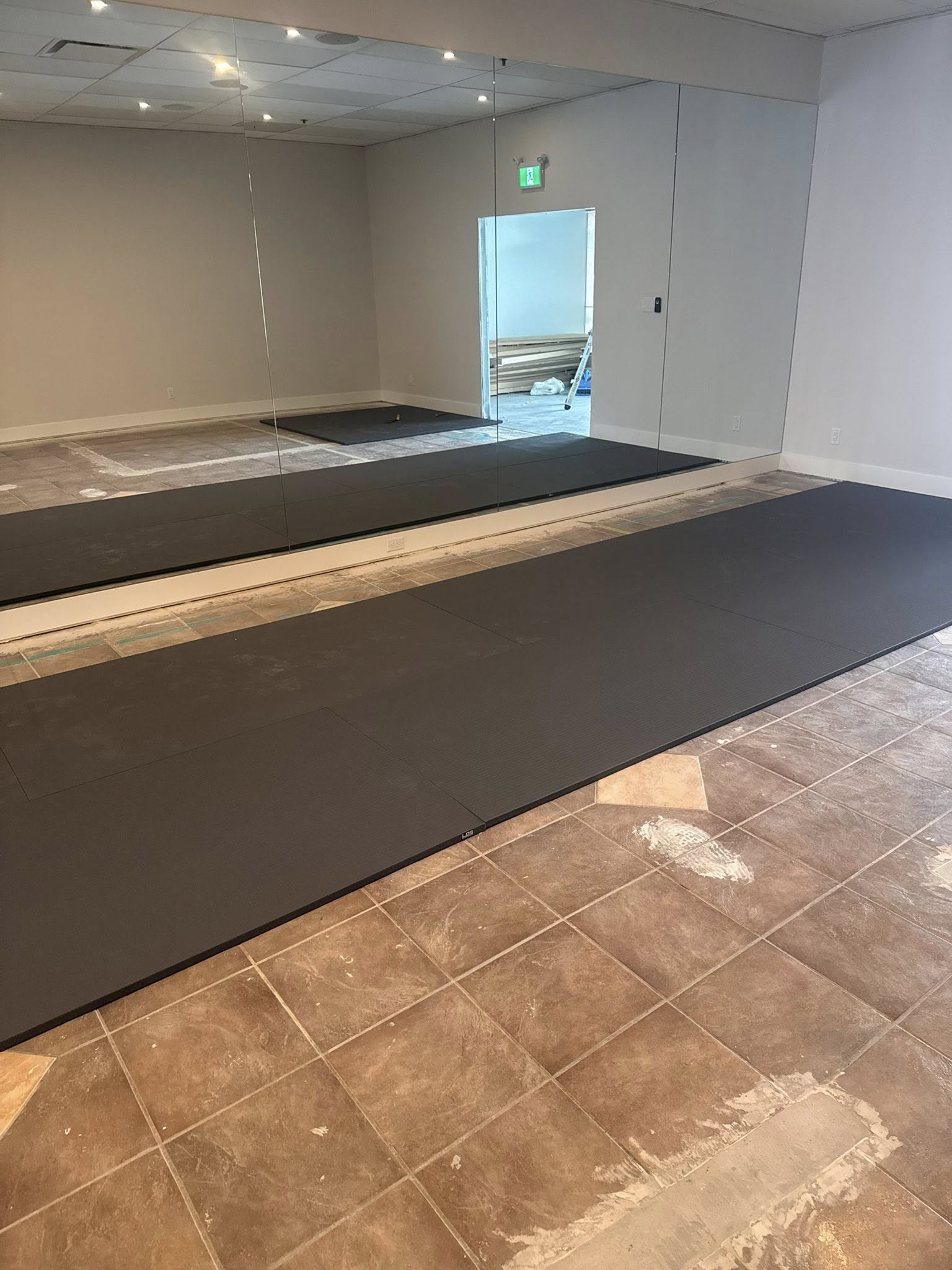 Yoga studio floor before final mat and baseboard installation, Langley commercial renovation