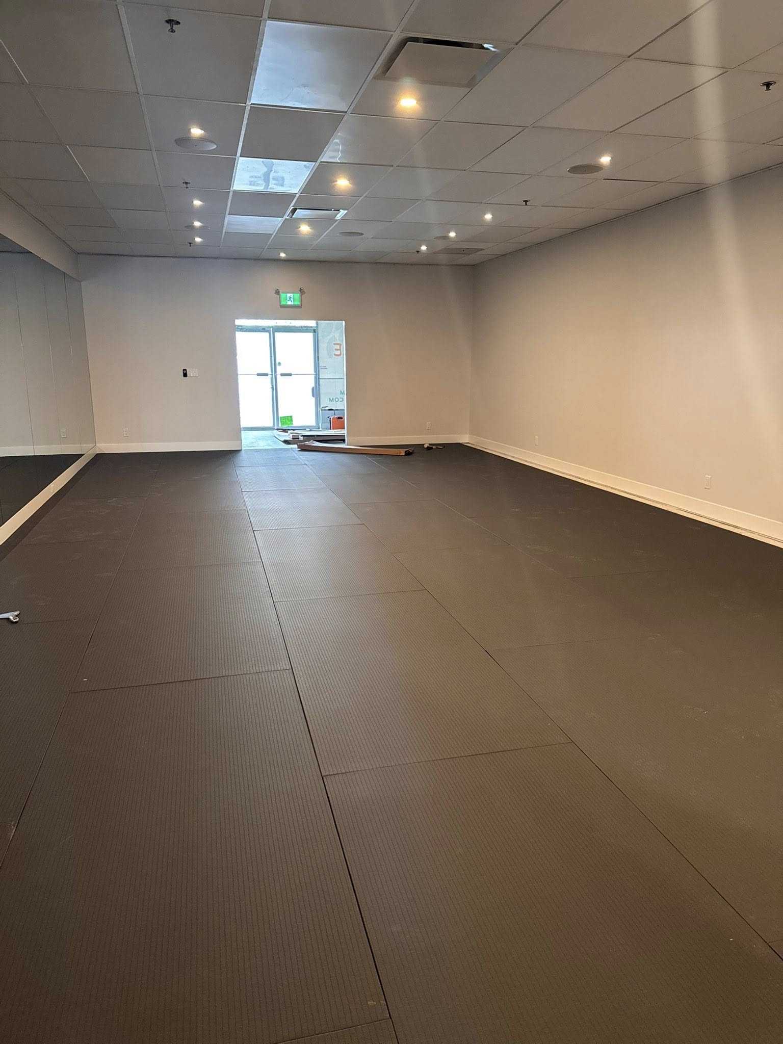Vinyl tile and yoga mat installation detail in finished commercial studio, Langley BC